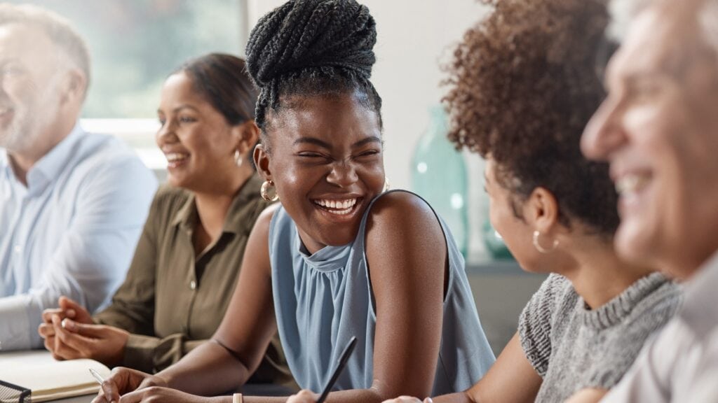 Laughter can brighten up your day. Shot of a group of businesspeople in a meeting at work.